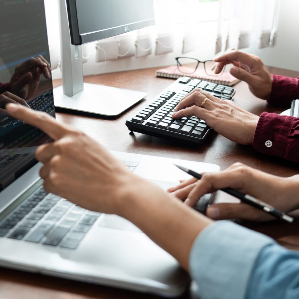 Team of Programmer working to find solution to problem and coding technologies in a software developing company office